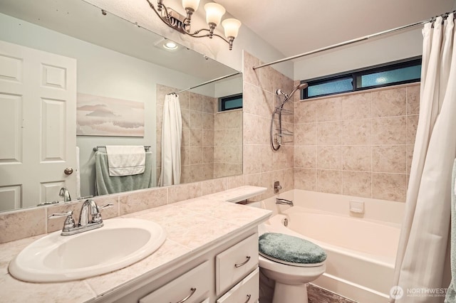 full bath with vanity, a notable chandelier, toilet, and shower / bath combo