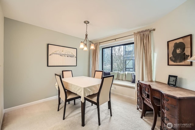 dining area with baseboards, light carpet, and a notable chandelier