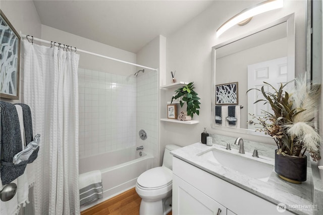 full bath with vanity, shower / bath combo with shower curtain, wood finished floors, and toilet