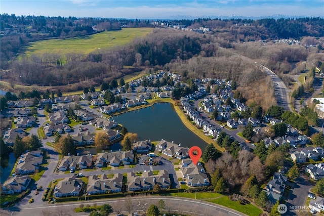 drone / aerial view with a water view and a residential view