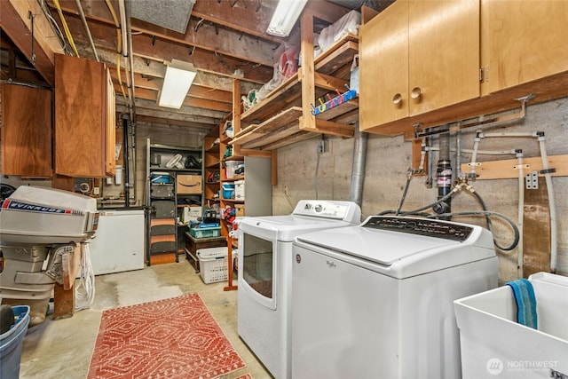 washroom with cabinet space and washing machine and dryer