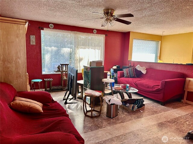 living area featuring a healthy amount of sunlight and a textured ceiling