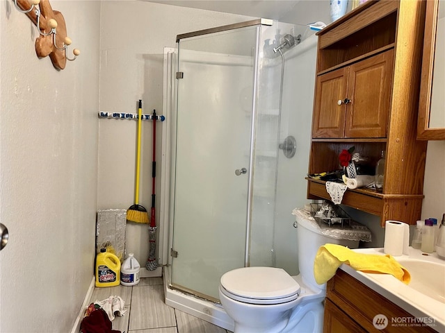 bathroom featuring a stall shower, vanity, and toilet