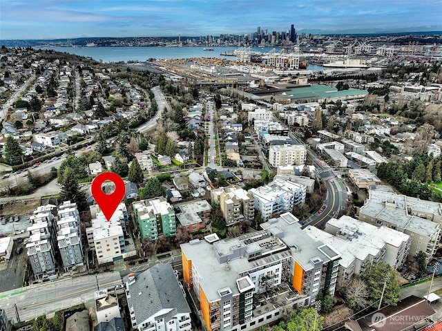 birds eye view of property with a view of city and a water view