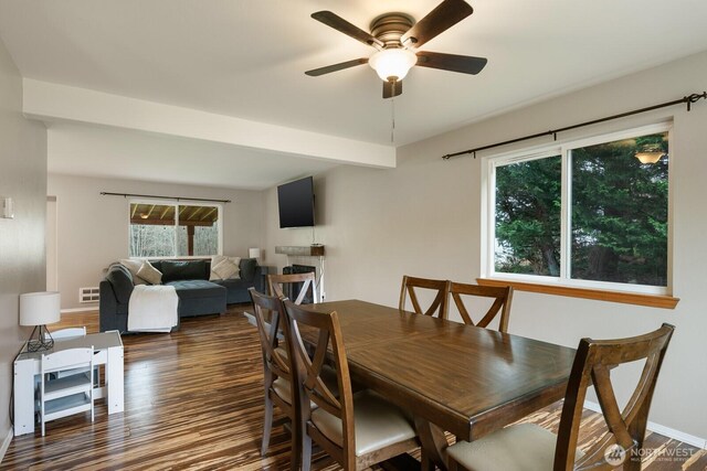 dining area featuring visible vents, a ceiling fan, wood finished floors, a fireplace, and baseboards