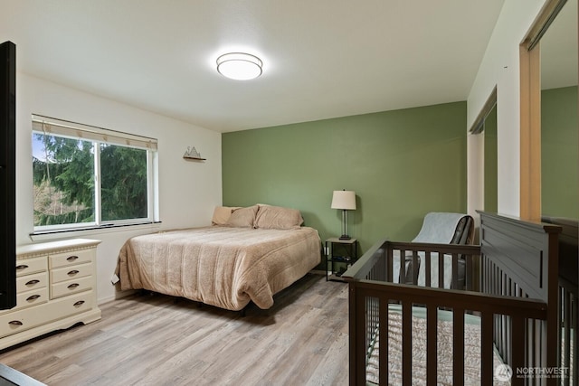 bedroom featuring light wood-style flooring