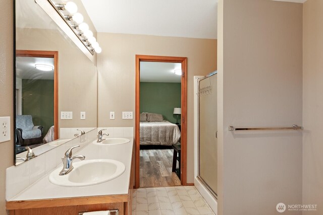 ensuite bathroom with a sink, connected bathroom, and a shower stall