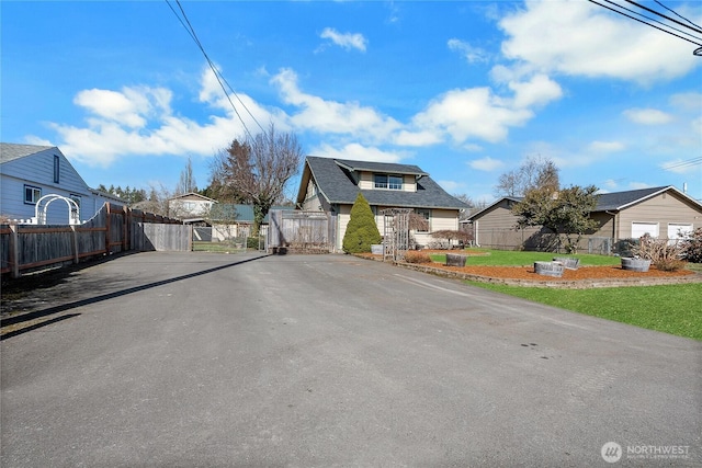 view of street with a residential view and a gate