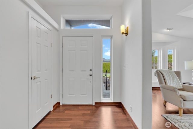 entryway with baseboards, dark wood-style flooring, and vaulted ceiling