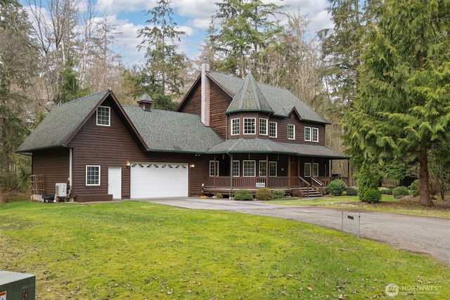 view of front of property with a porch, a chimney, a front lawn, a garage, and aphalt driveway