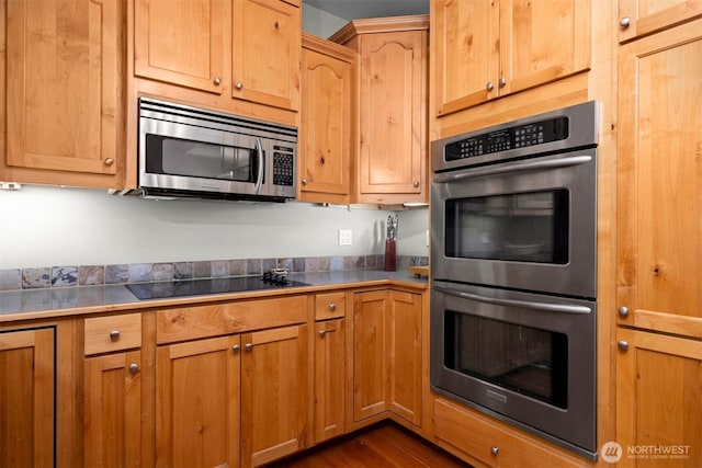 kitchen featuring dark wood-type flooring and appliances with stainless steel finishes