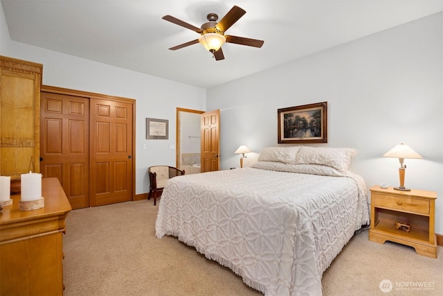 bedroom featuring a closet, light carpet, and a ceiling fan