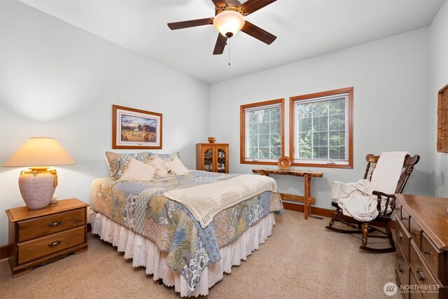 carpeted bedroom featuring ceiling fan and baseboards