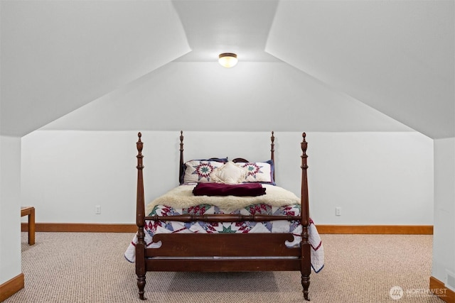 bedroom featuring vaulted ceiling, visible vents, baseboards, and carpet floors