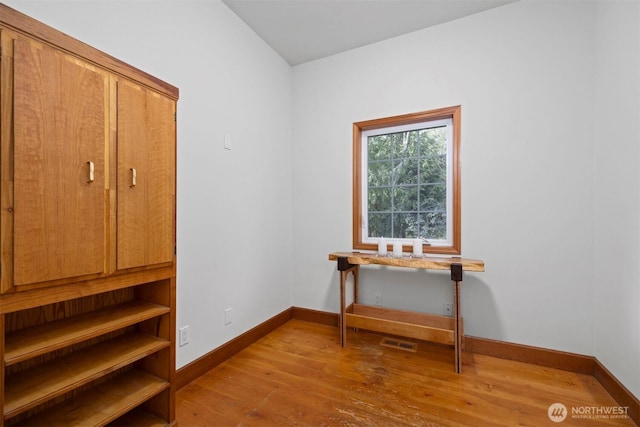 interior space featuring visible vents, baseboards, and wood finished floors