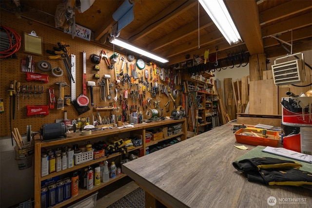 miscellaneous room featuring a workshop area and a wall mounted AC