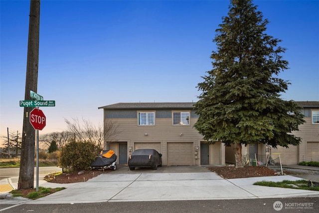 view of front of property featuring concrete driveway and an attached garage