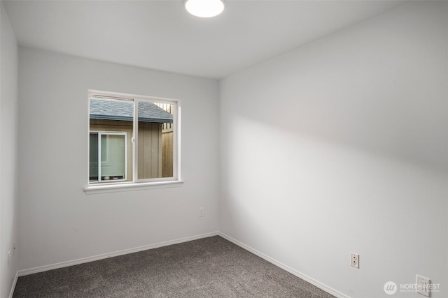 carpeted empty room with baseboards