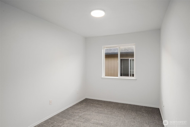 carpeted empty room with baseboards