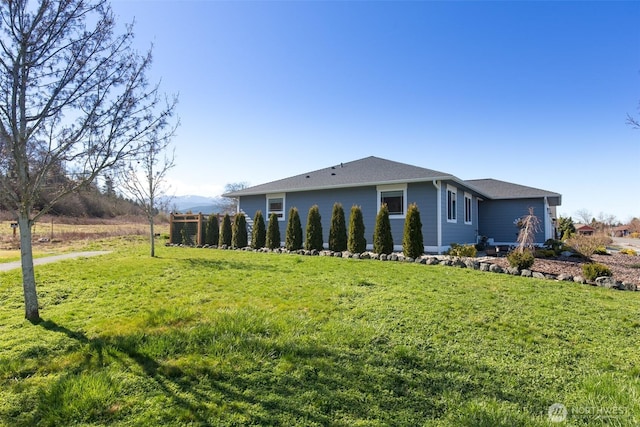 view of side of home with a lawn