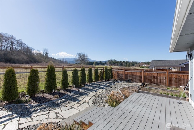 deck featuring fence and a mountain view