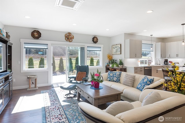 living area featuring dark wood-style floors, recessed lighting, and visible vents