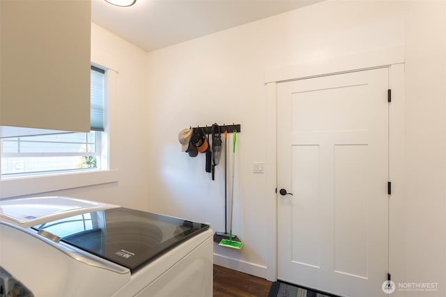 washroom with laundry area, washing machine and dryer, and dark wood-style flooring