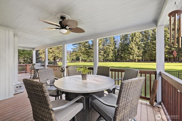 sunroom / solarium featuring ceiling fan