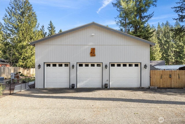 detached garage featuring fence