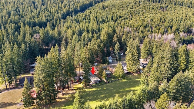 drone / aerial view featuring a wooded view