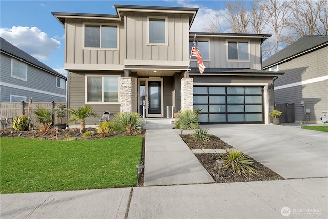 view of front of house with a garage, concrete driveway, fence, board and batten siding, and a front yard