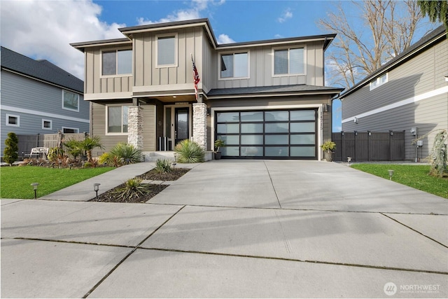 view of front facade with board and batten siding, concrete driveway, and fence