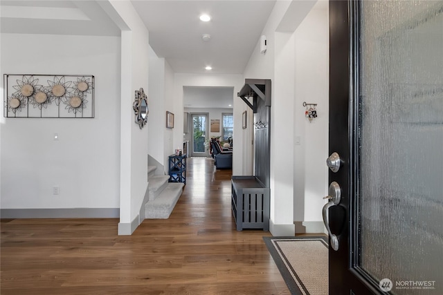 foyer with baseboards, stairway, wood finished floors, and recessed lighting