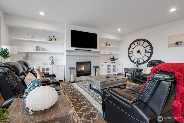 living room featuring a fireplace, wood finished floors, and recessed lighting