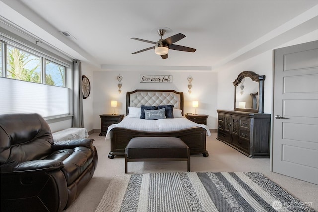 bedroom with light colored carpet, visible vents, and ceiling fan