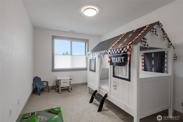 bedroom with carpet floors, visible vents, and baseboards