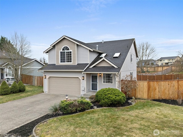 traditional-style home with driveway, an attached garage, fence, and a front yard