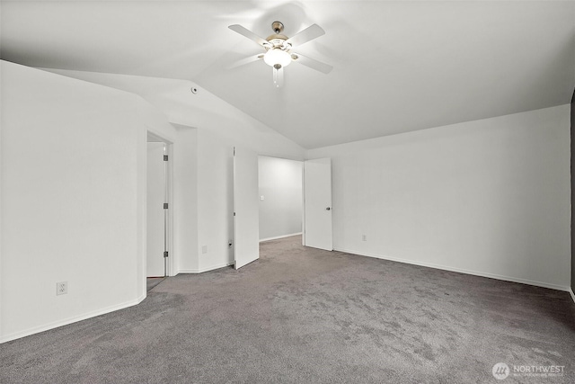 carpeted spare room with lofted ceiling, ceiling fan, and baseboards