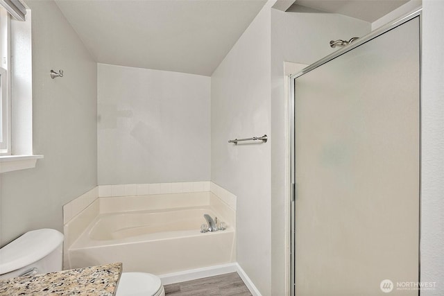 full bathroom featuring toilet, a garden tub, wood finished floors, and a stall shower