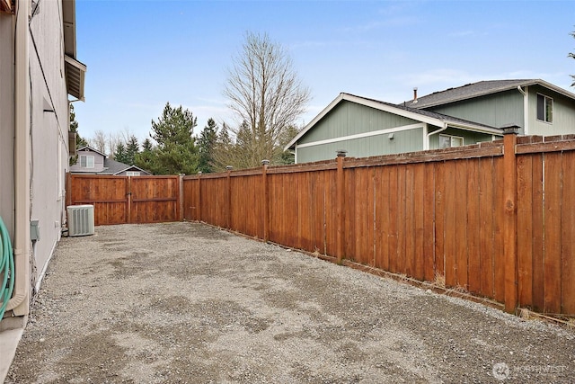 view of yard featuring a fenced backyard, a patio, and central AC unit