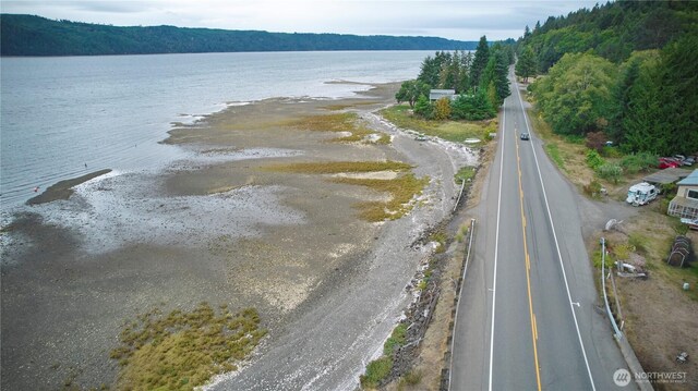 aerial view with a forest view and a water view