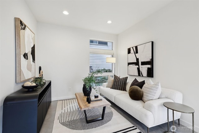 living area featuring recessed lighting and baseboards