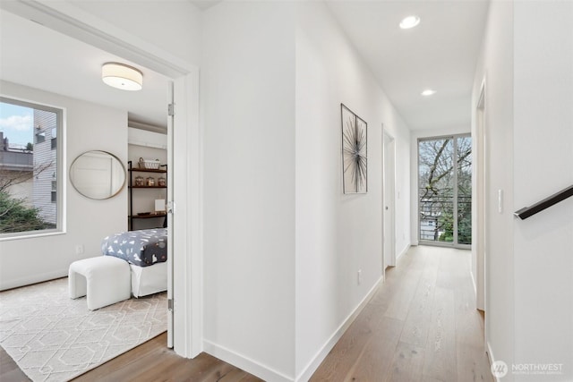 hallway with recessed lighting, baseboards, and wood finished floors