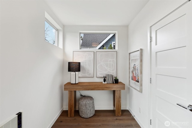 home office with wood finished floors, visible vents, and baseboards