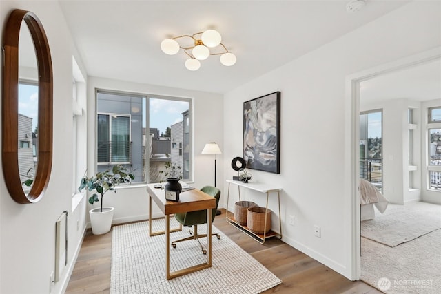 office with visible vents, baseboards, a notable chandelier, and wood finished floors