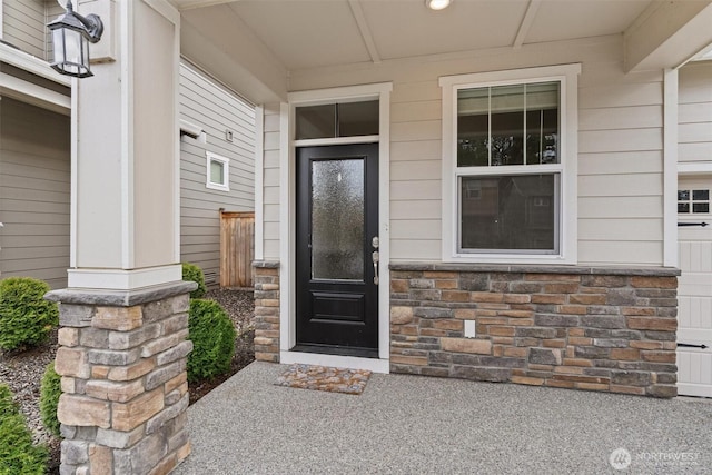 entrance to property featuring stone siding