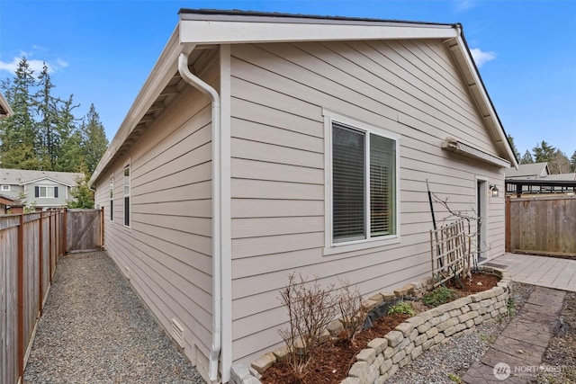 view of side of home featuring a fenced backyard