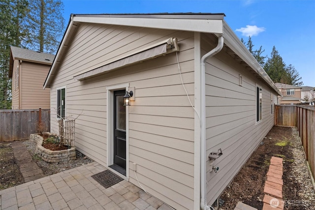 exterior space with a fenced backyard and a patio area