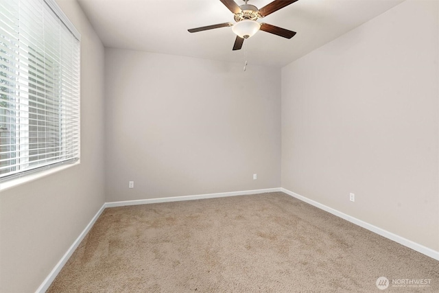 carpeted empty room with baseboards and ceiling fan