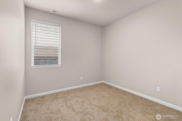 unfurnished room featuring visible vents, baseboards, and carpet